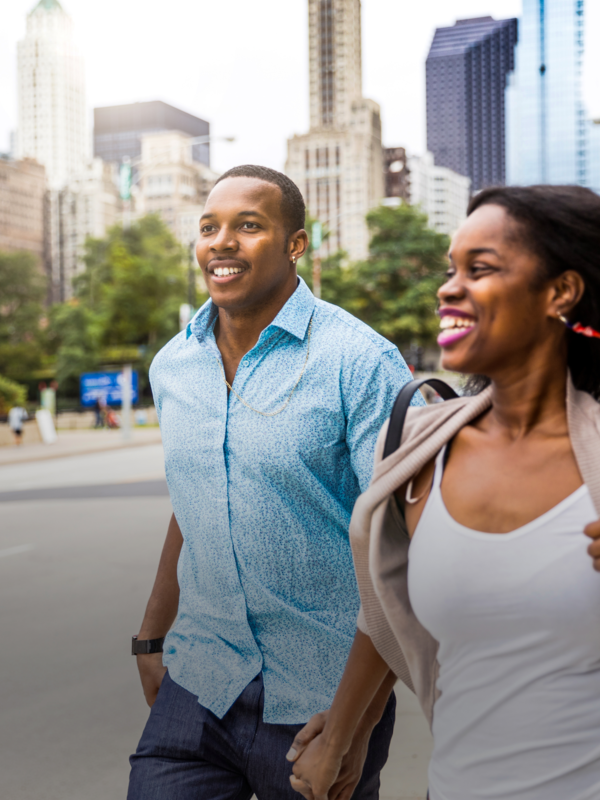 two people run along sidewalk