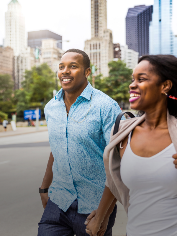 two people run along sidewalk