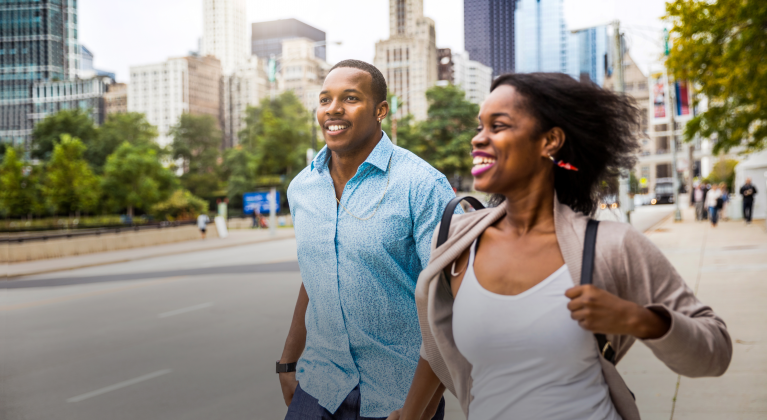 two people run along sidewalk