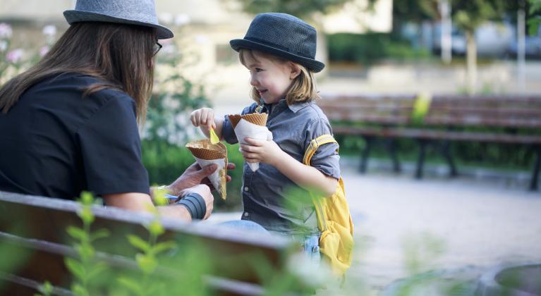 child shares food with adult